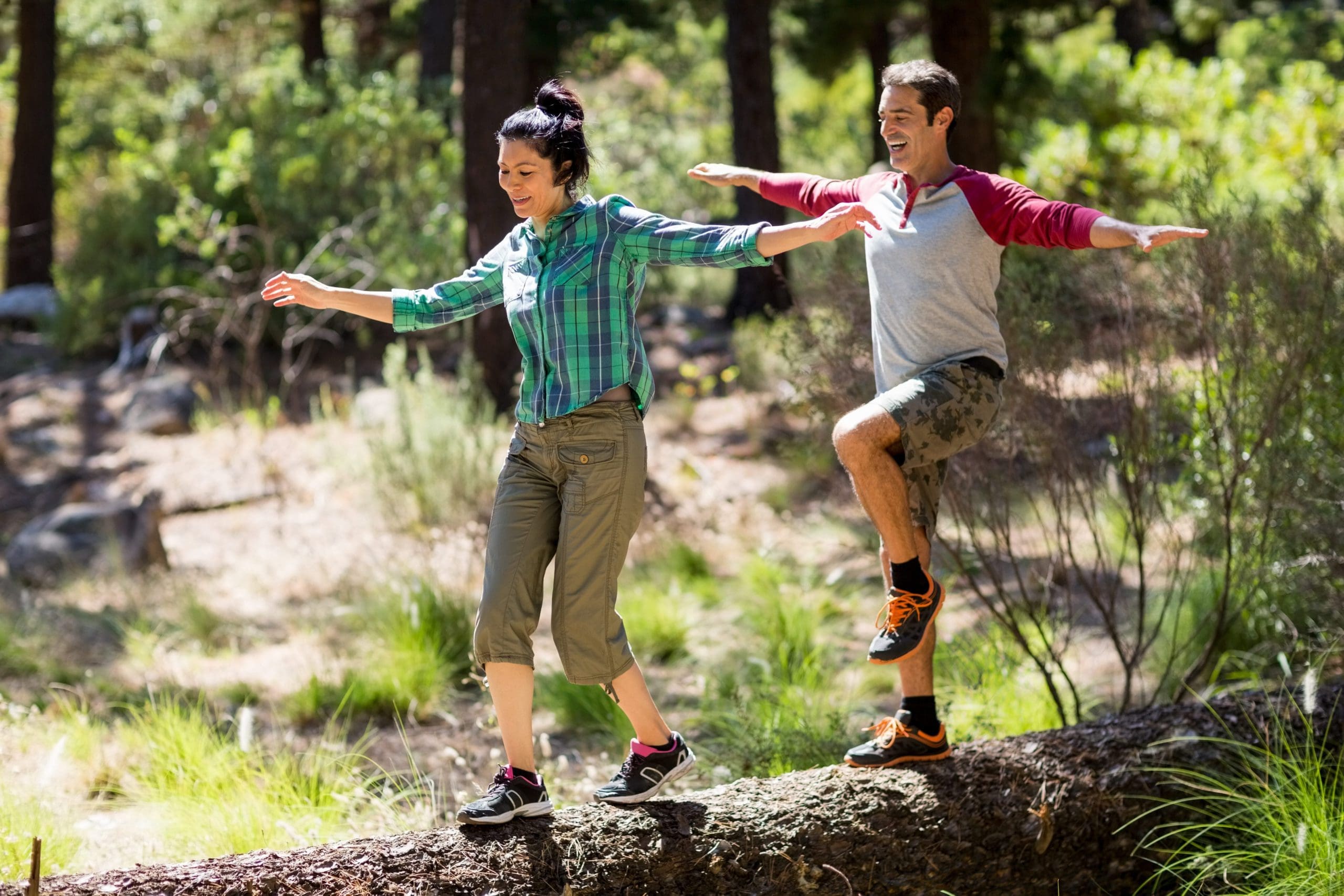 Men and women balancing on a log while hiking in the Black Hills