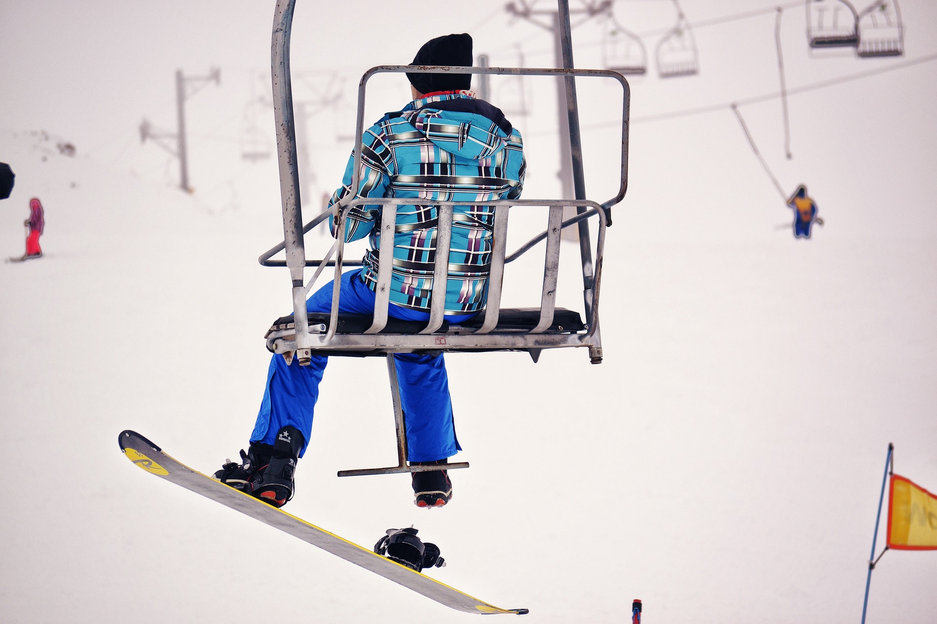 snowboarder riding chair lift